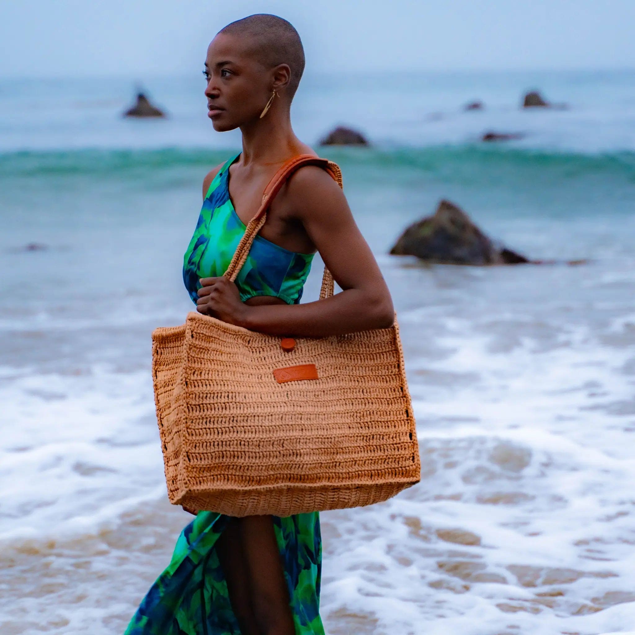 Beach bag and model walking on the beach