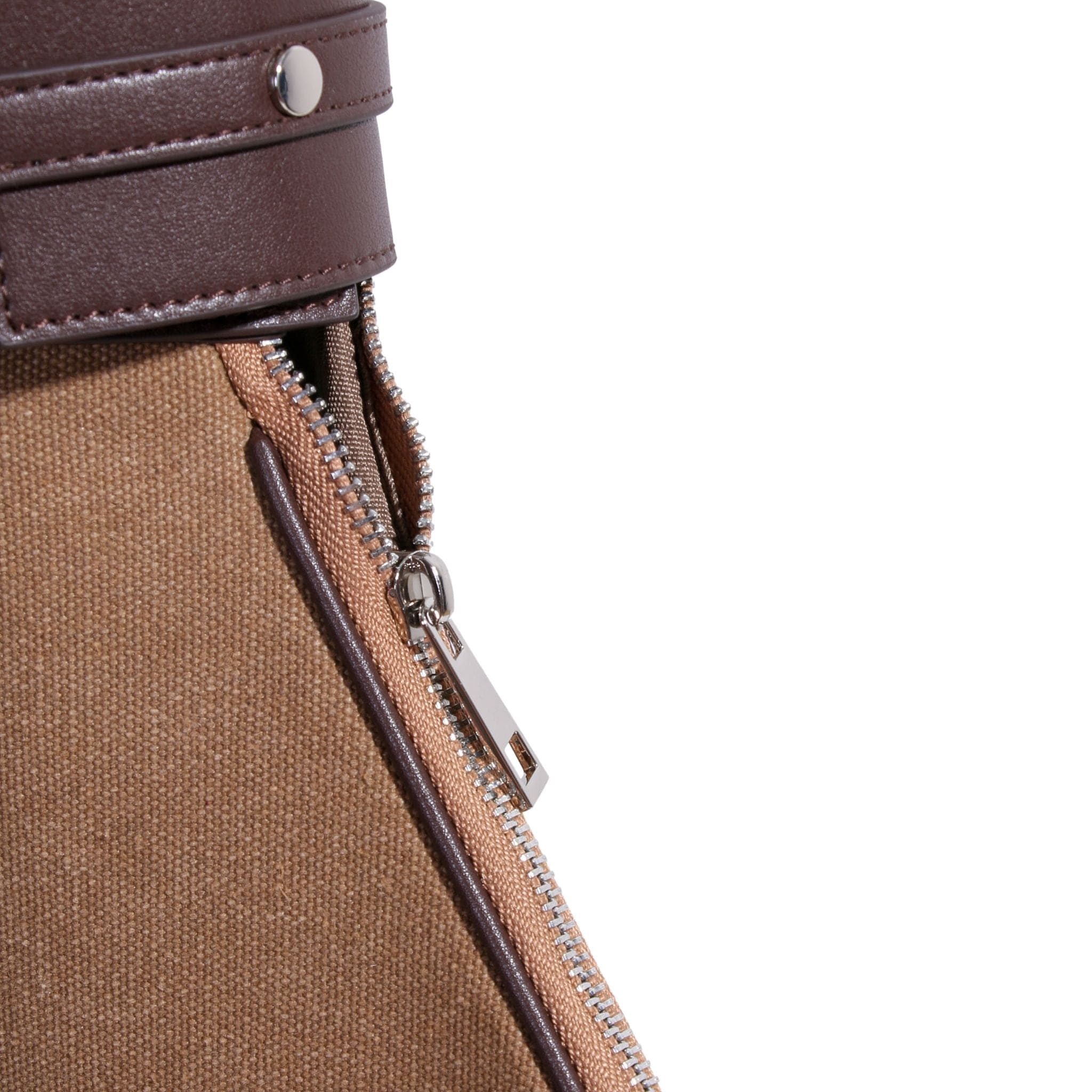 Close-up of a brown canvas tennis bag with a partially opened silver zipper and a leather strap featuring a metal button at the top.