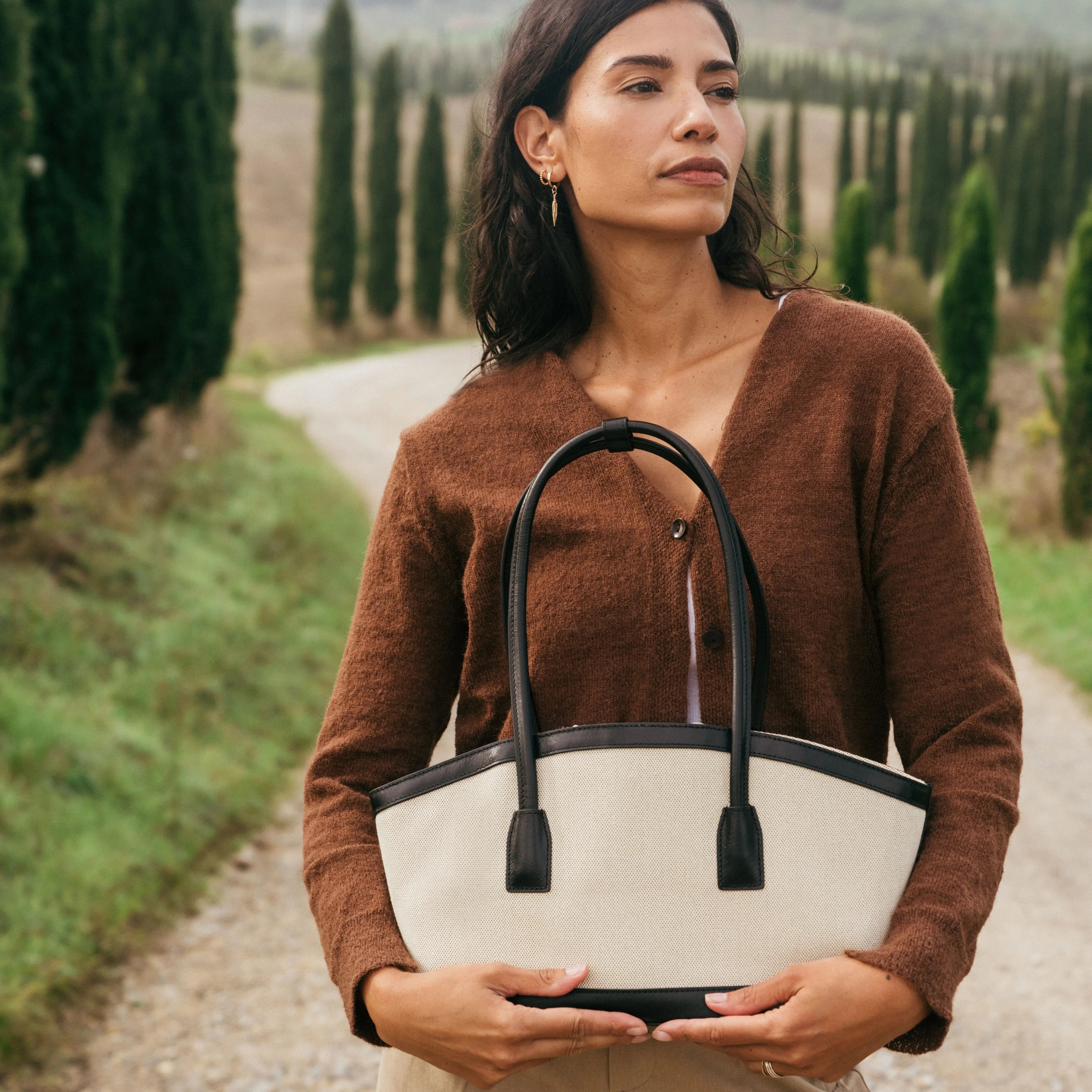 Canvas shoulder tote bag with drawstring closure and black leather details