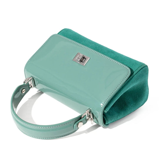 Mint handbag with a strap on a white background, showcasing the patent leather and craftsmanship.