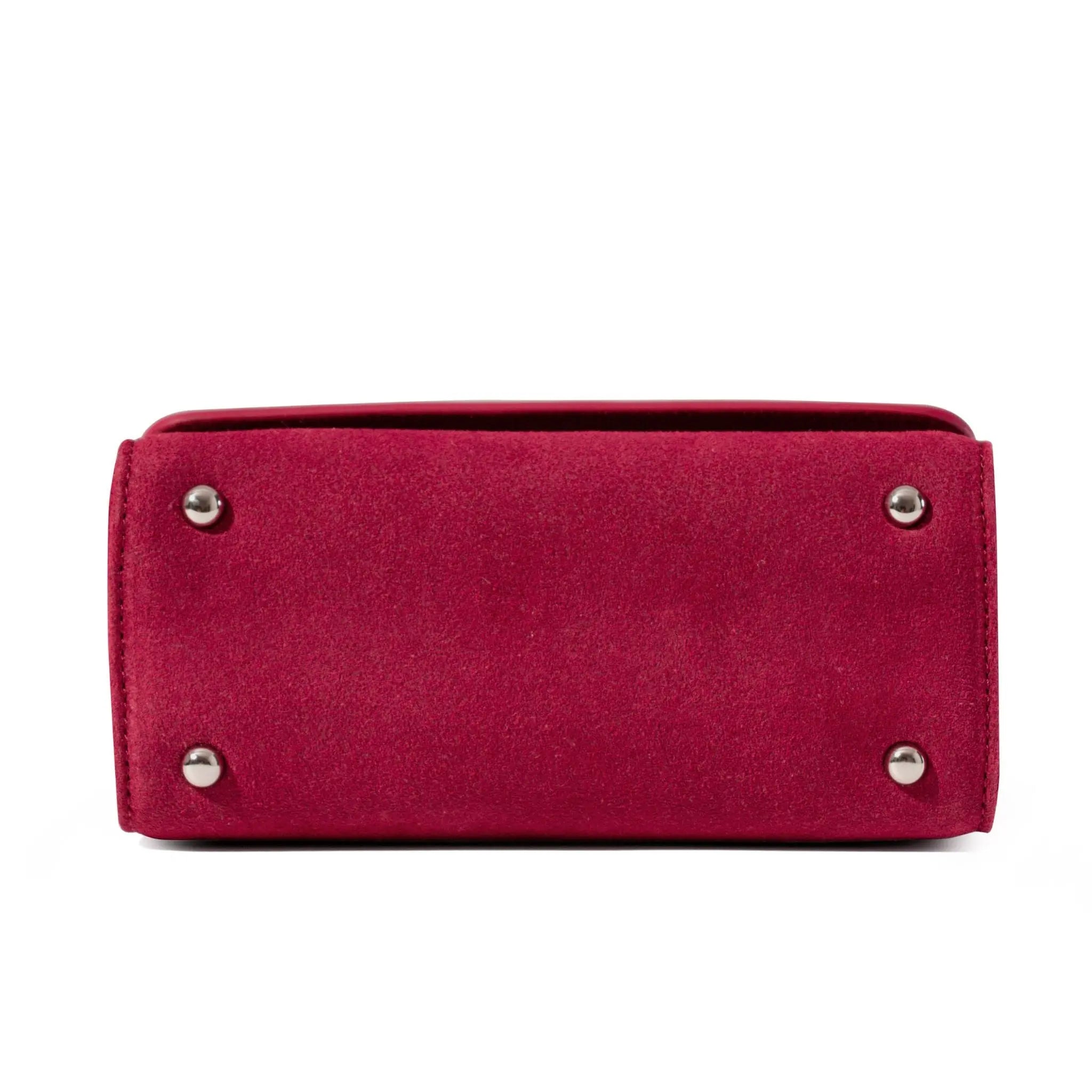 Red clutch bag with silver studs to protect the handbag