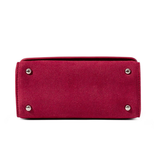 Red clutch bag with silver studs to protect the handbag