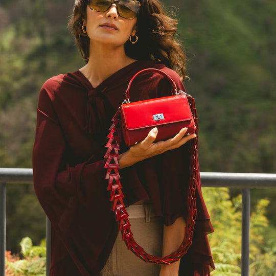 Woman holding a red handbag from suede and leather from JURGI Brand
