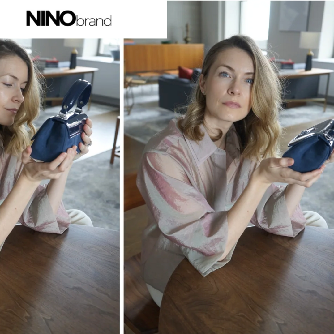 Woman holding a blue object in a room with furniture and a lamp.