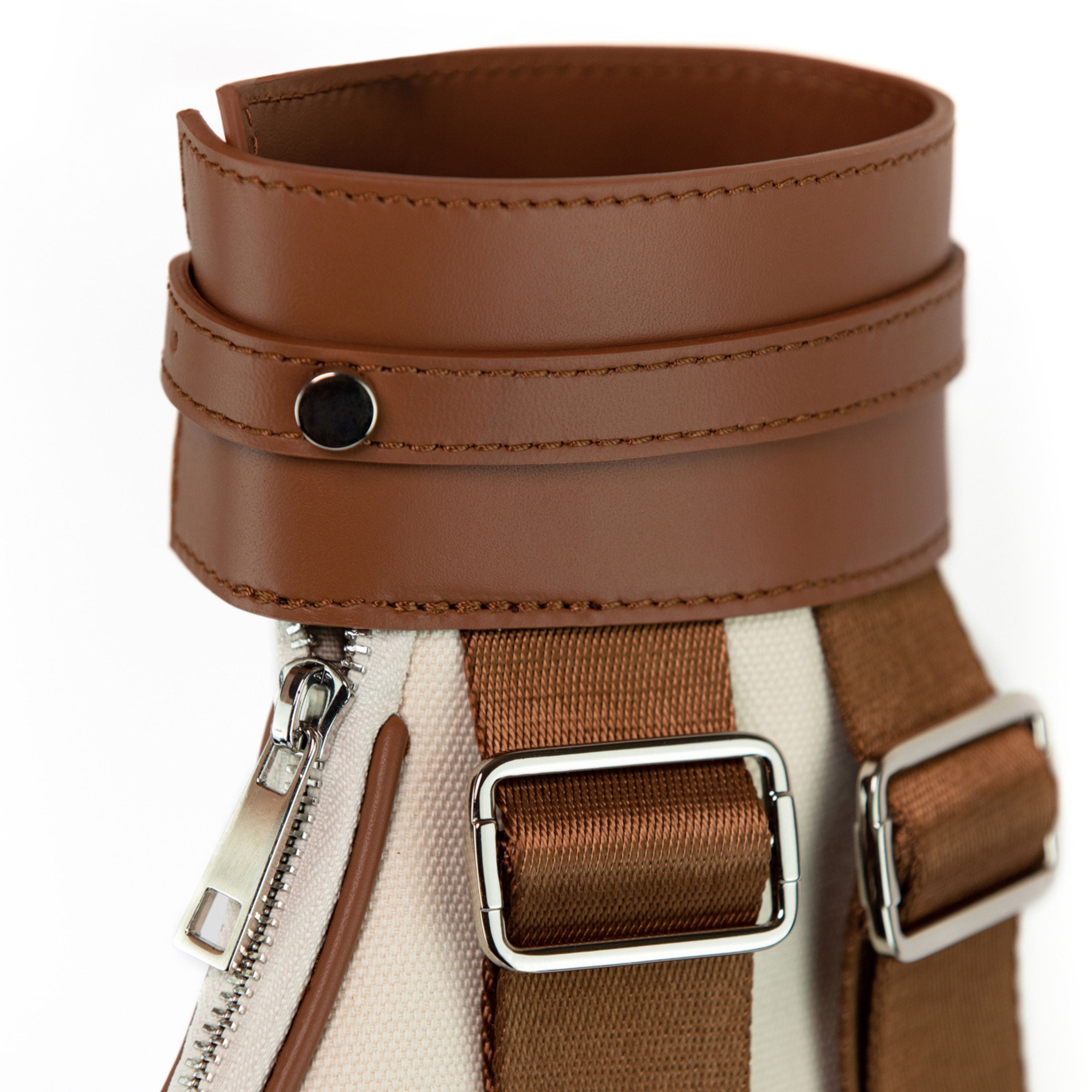 Close-up of a brown leather strap with buckles on a white background