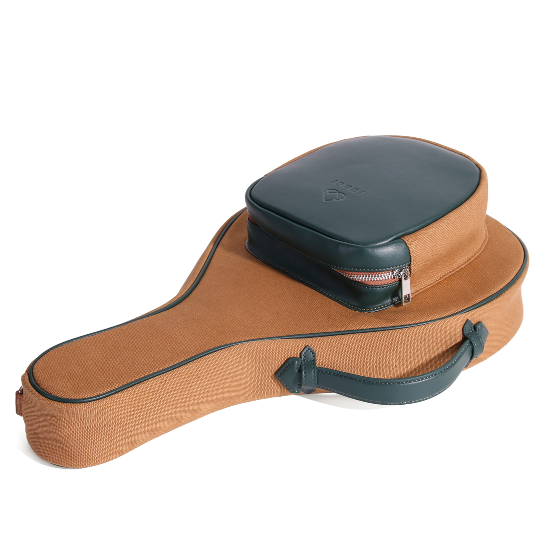 Side view of brown padel bag featuring green top compartment