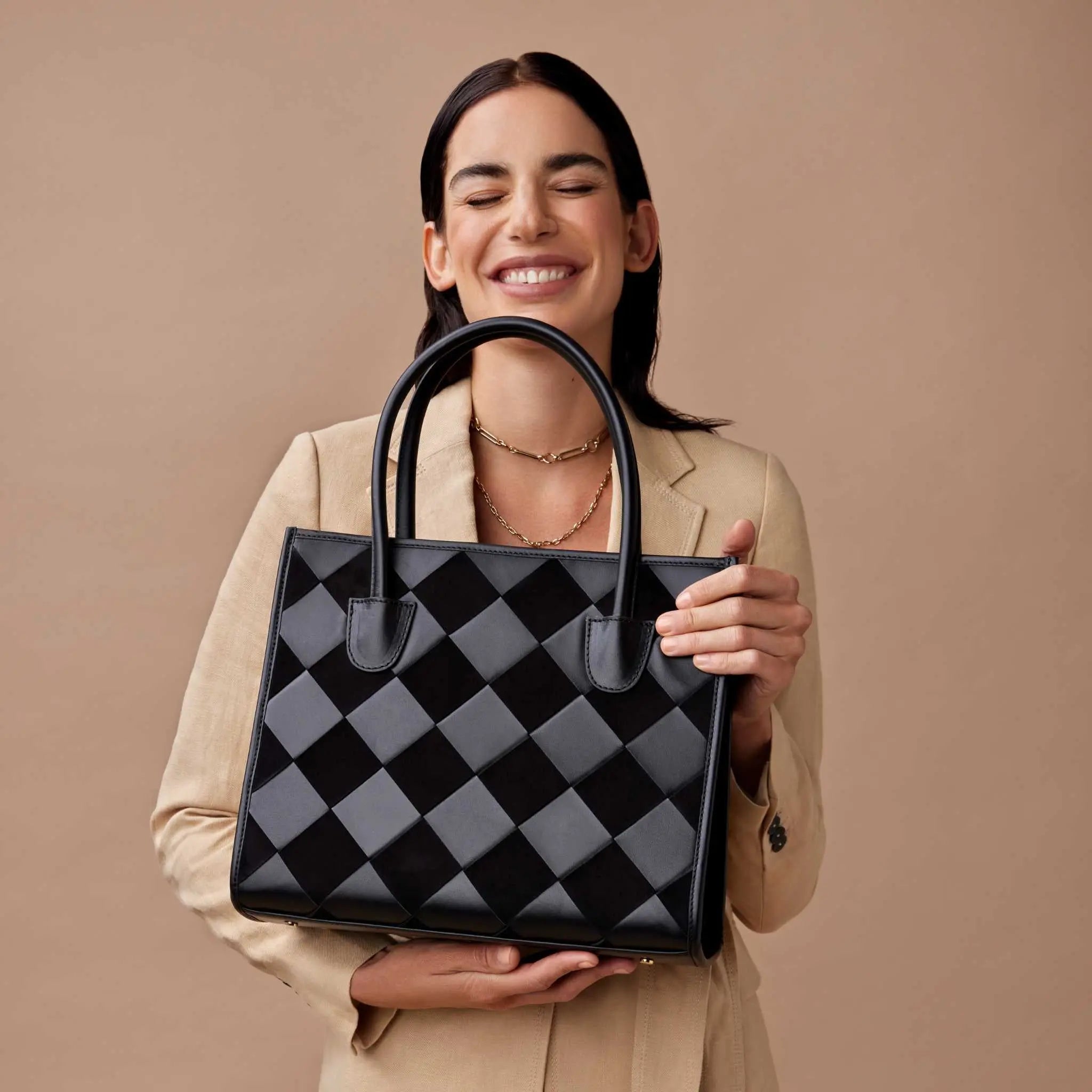 JURGI black woven handbag crafted from suede and calfskin leather