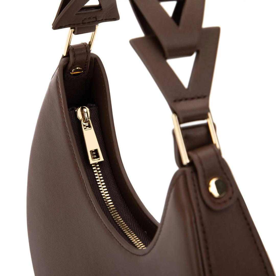 Handcrafted brown leather purse with a moon-shaped handle