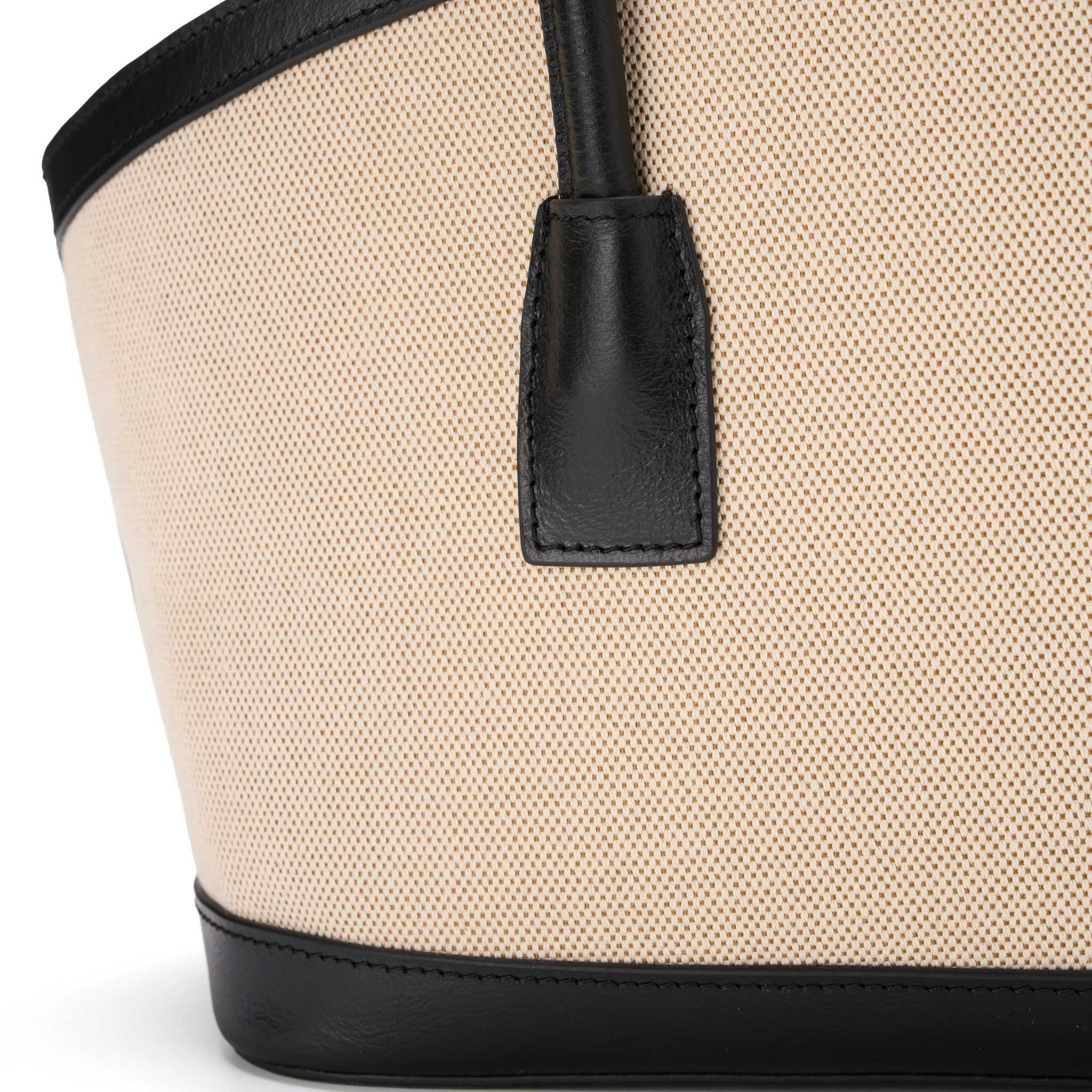 Canvas shoulder tote bag with drawstring closure and black leather details