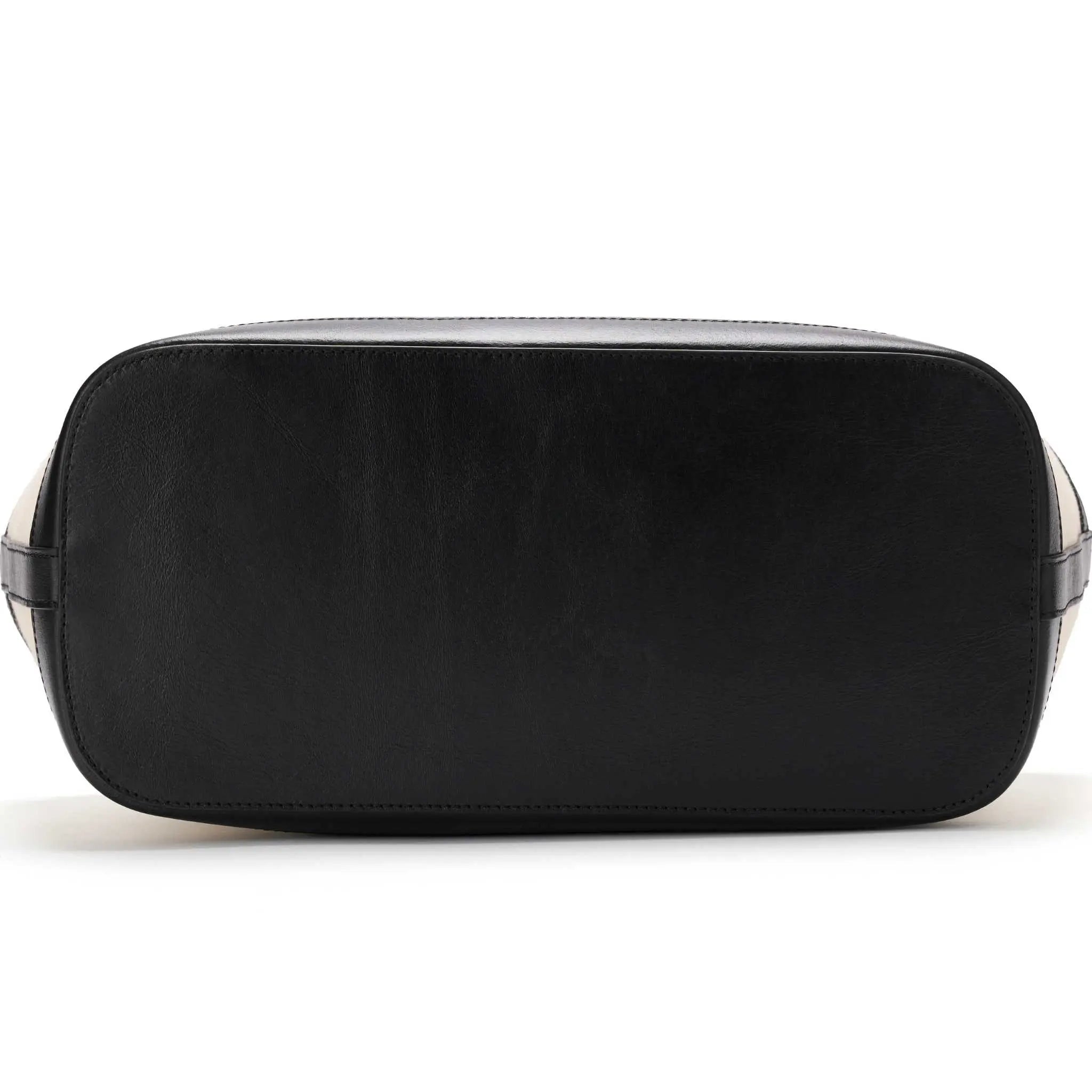 Elegant canvas handbag trimmed with black leather bottom